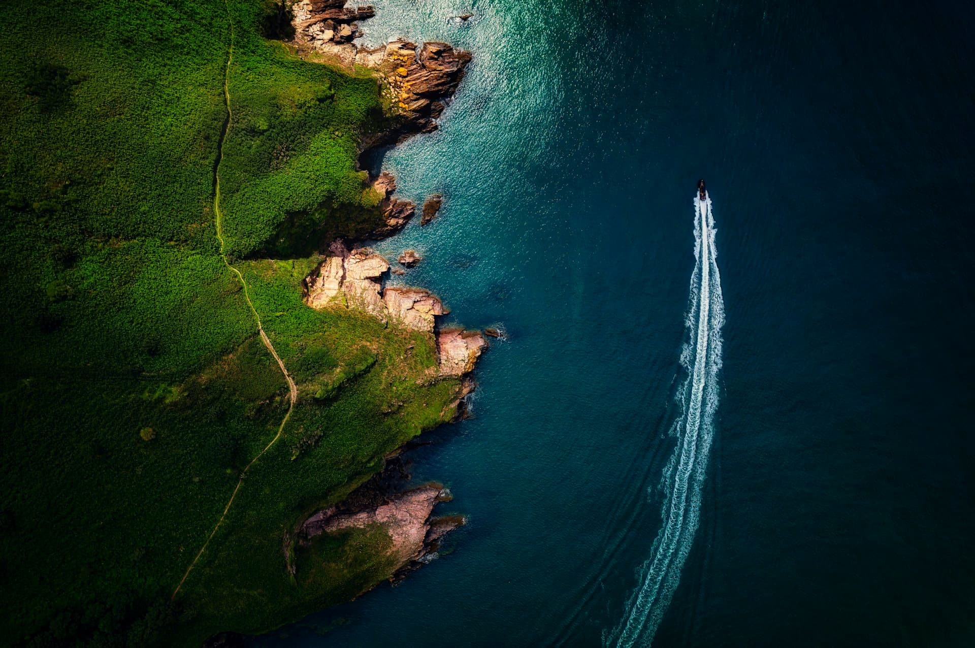 Offshore powerboat cutting a clean wake across open coastal water